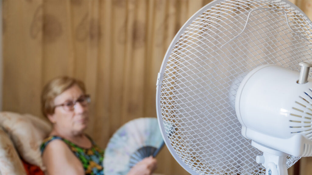 A woman cools herself from the heat (iStock image)