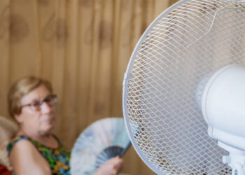 A woman cools herself from the heat (iStock image)