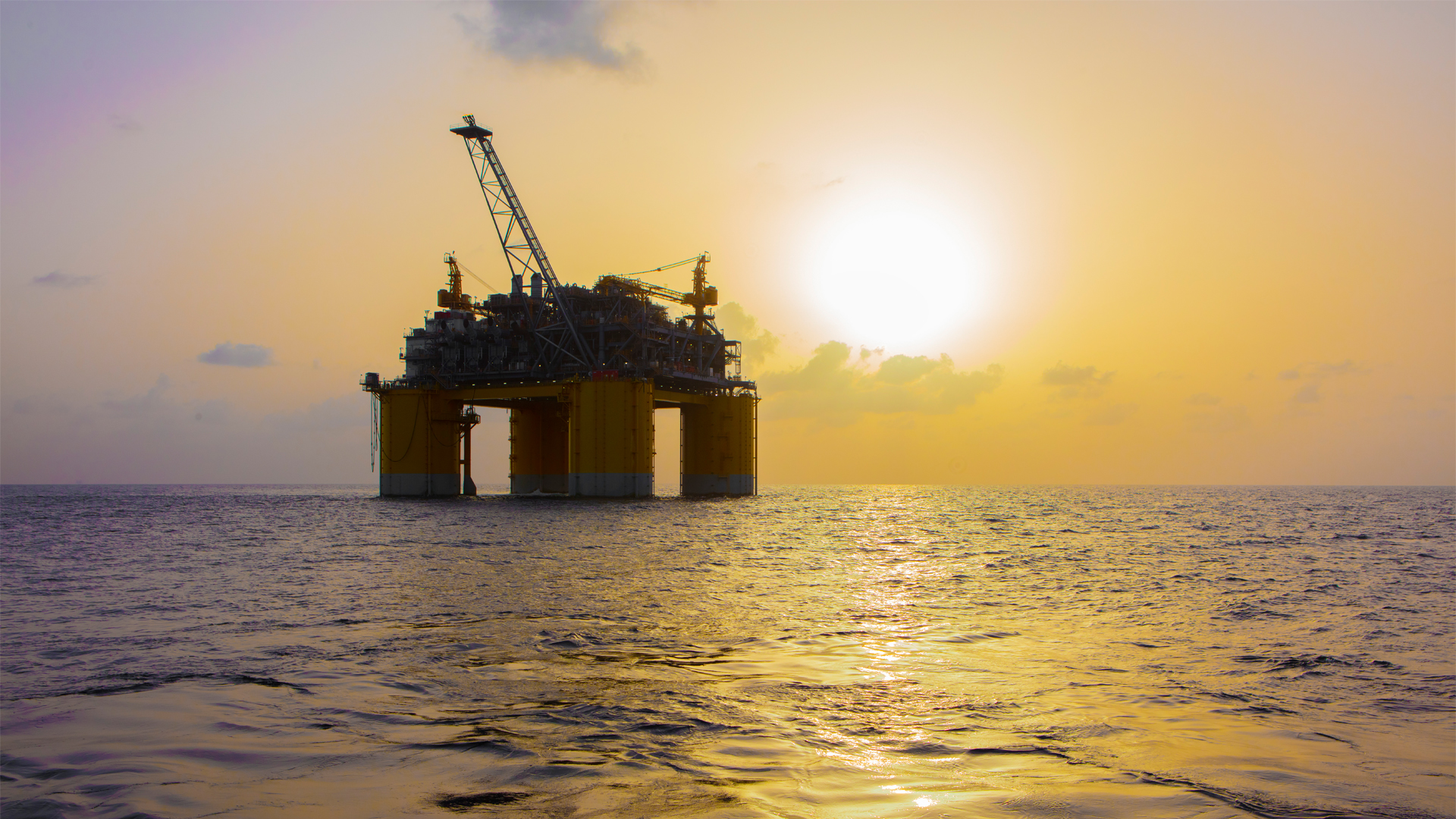 An offshore drilling platform at sunset in the Gulf (iStock image)