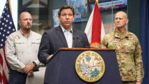 Florida Gov. Ron DeSantis, seen here at a press briefing on Hurricane Ian in 2022, has approved funding for coastal communities to adapt to flooding and protect themselves against hurricanes but calls it “strengthening and fortifying Florida” without any mention of climate change. (Robert Kaufmann/FEMA, via Defense Visual Information Distribution Service)