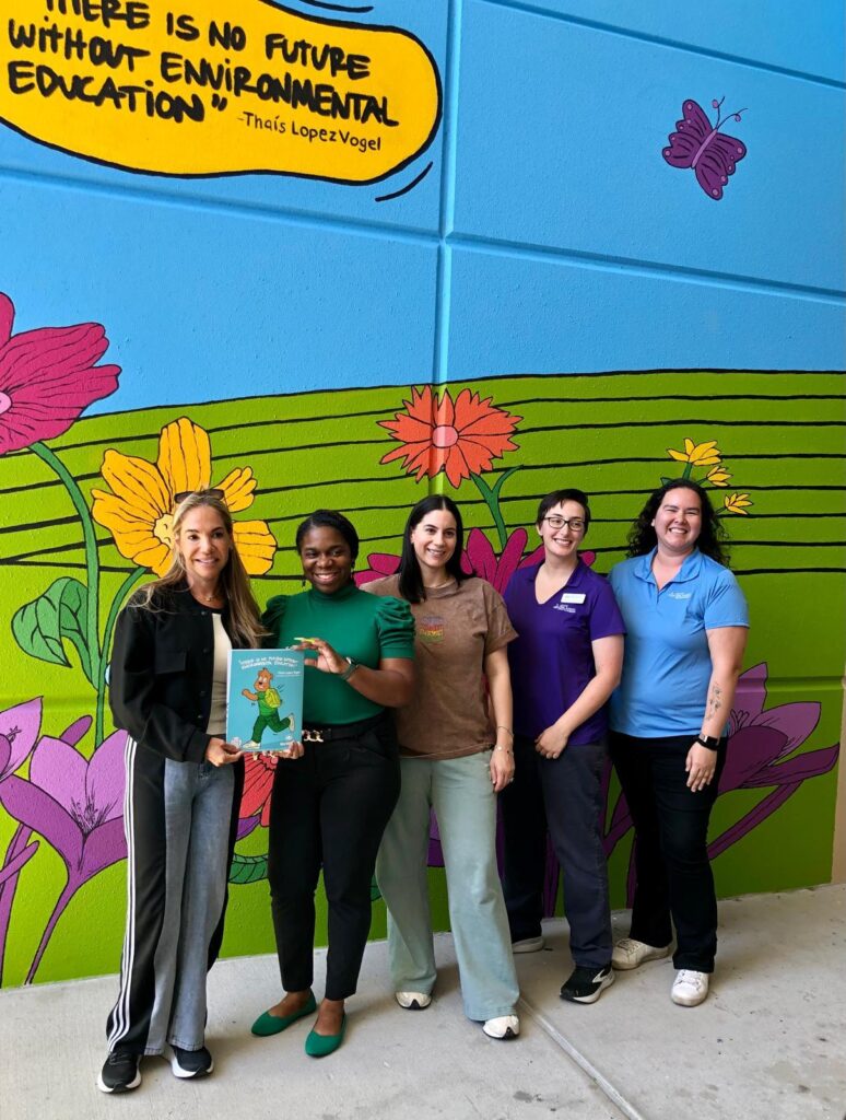 (Left to right) VoLo Foundation co-founder Thais Lopez Vogel, Principal Natasha Pender, artist Allison Dayka, Madison Szathmary of Keep Orlando Beautiful and her colleague in front of the mural at the Orange County Public Schools Academic Center for Excellence. (Photo courtesy of VoLo Foundation)