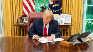 President Donald Trump signs an executive order on expediting permitting in 2020 in the Oval Office of the White House. (Official White House Photo by Shealah Craighead, Public domain, via Wikimedia Commons)