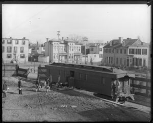 Men carry pails of fish specimens to a U.S. Fish Commission ‘fish car’ – a train car designed specifically for transporting fish or fish eggs to stock U.S. rivers, lakes and coastal waters – in this historical photo. (Smithsonian Institution Archives)
