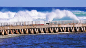 Waves crash against a seawall in South Florida (iStock image)