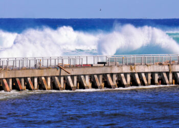 Waves crash against a seawall in South Florida (iStock image)