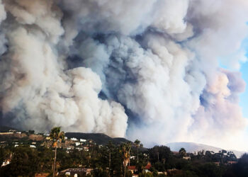 Florida State University researchers will use new funding from the National Science Foundation to investigate mechanisms that drive wildfire spread including how smoke plumes, like these seen over a fire in California, behave and interact with atmospheric stratification and topography. (iStock image)