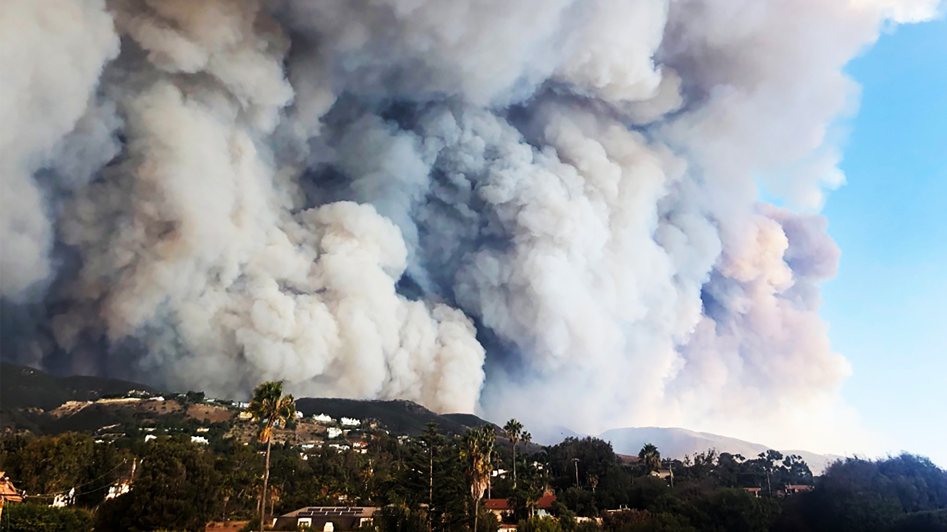 Florida State University researchers will use new funding from the National Science Foundation to investigate mechanisms that drive wildfire spread including how smoke plumes, like these seen over a fire in California, behave and interact with atmospheric stratification and topography. (iStock image)