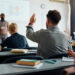 A student raises his hand in a classroom (iStock image)