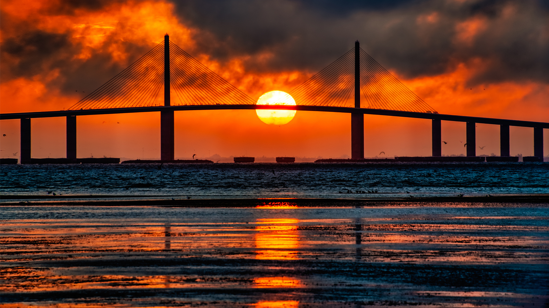 The sun sets behind the Sunshine Skyway bridge over Tampa Bay. (iStock image)