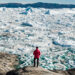 A man looks at melting ice in Greenland (iStock image)