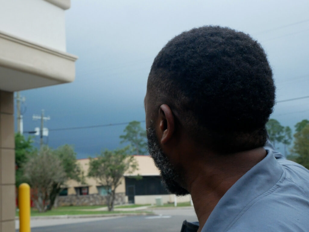 AJ collects his belongings as he formulates a plan to wait out an impending thunderstorm. (Credit: Des Lewis)