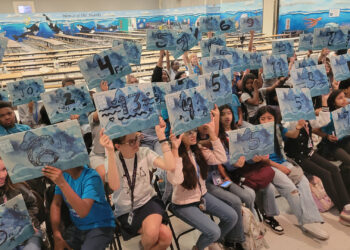Broward County has brought climate-themed art workshops to middle and high schools through “The Underwater: Broward” initiative with artist Xavier Cortada. Students create small artworks with their home's elevation above sea level that they can display to raise awareness. (Photo courtesy of Broward County)