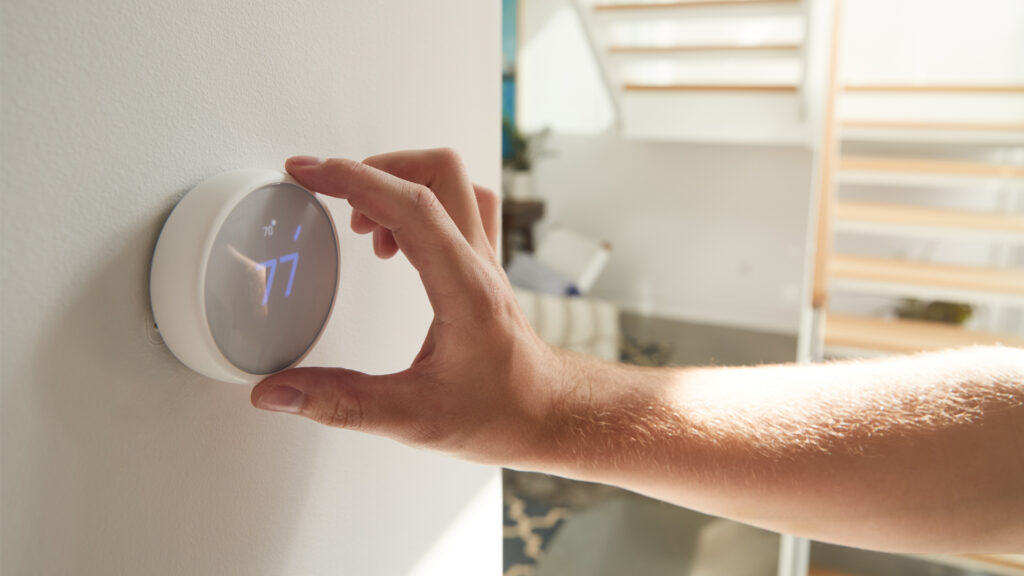 A digital thermostat being adjusted (iStock image)