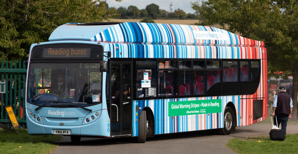 A bus covered in warming stripes in the town of Reading in England, where they were first created. (km30192002, CC BY 2.0, via Wikimedia Commons)