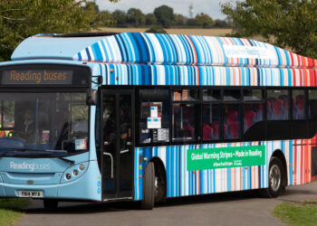 A bus covered in warming stripes in the town of Reading in England, where they were first created. (km30192002, CC BY 2.0, via Wikimedia Commons)