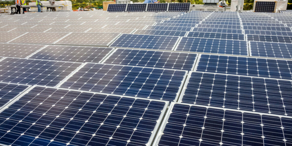A rooftop solar array being installed in Broward County (Paul Krashefski/U.S. Department of Energy, Public domain, via Wilimedia Commons)