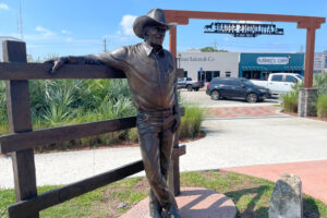 Cattleman’s Square celebrates Okeechobee’s ranching roots with statues depicting a cattle drive. Nearby, an arena features a few rodeos a year and hosts the state’s largest livestock market, with auctions on Mondays and Tuesdays selling on average 1,200 head of cattle daily. (Credit: Amy Green/Inside Climate News)