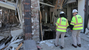 National Transportation Safety Board investigators walk the scene of a natural gas explosion in downtown Youngstown, Ohio, in 2024. (NTSB, Public domain, via Wikimedia Commons)