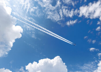 Airliner with contrails flying across the sky (iStock image)