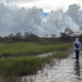 Curtis Osceola of the Miccosukee Tribe walks through the marsh less than two miles from Alligator Alcatraz. (Credit: Amy Green/Inside Climate News)