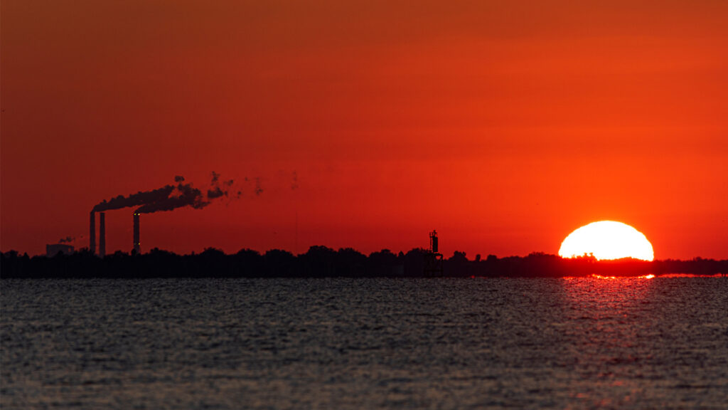 The sun rises near a Florida power plant (iStock image)