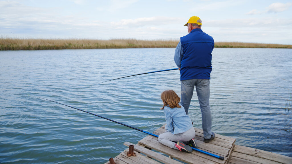 A grandfather and his granddaughter fishing (iStock image)