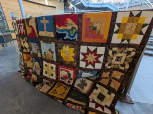 The memorial quilt in Greensburg’s Big Well Museum includes the tornado’s radar signature surrounded by other symbols of how residents have pieced the town back together. (Photo by Anne Vilen)