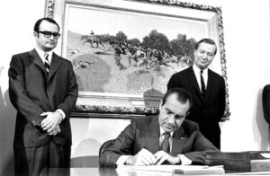 President Richard Nixon signing the Clean Air Act of 1970 at the White House. Looking on are William Ruckelshaus, administrator of the Environmental Protection Agency (left), and Russell E. Train, chairman of the Council on Environmental Quality. (White House Photo Office, Public domain, via Wikimedia Commons)