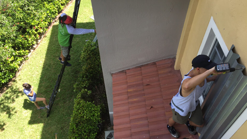 Doral residents install hurricane shutters in preparation for Hurricane Irma in 2017. (Cyclonebiskit, CC BY-SA 4.0, via Wikimedia Commons)