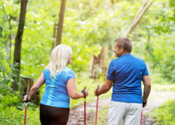 A senior couple walks on a nature trail. (iStock image)