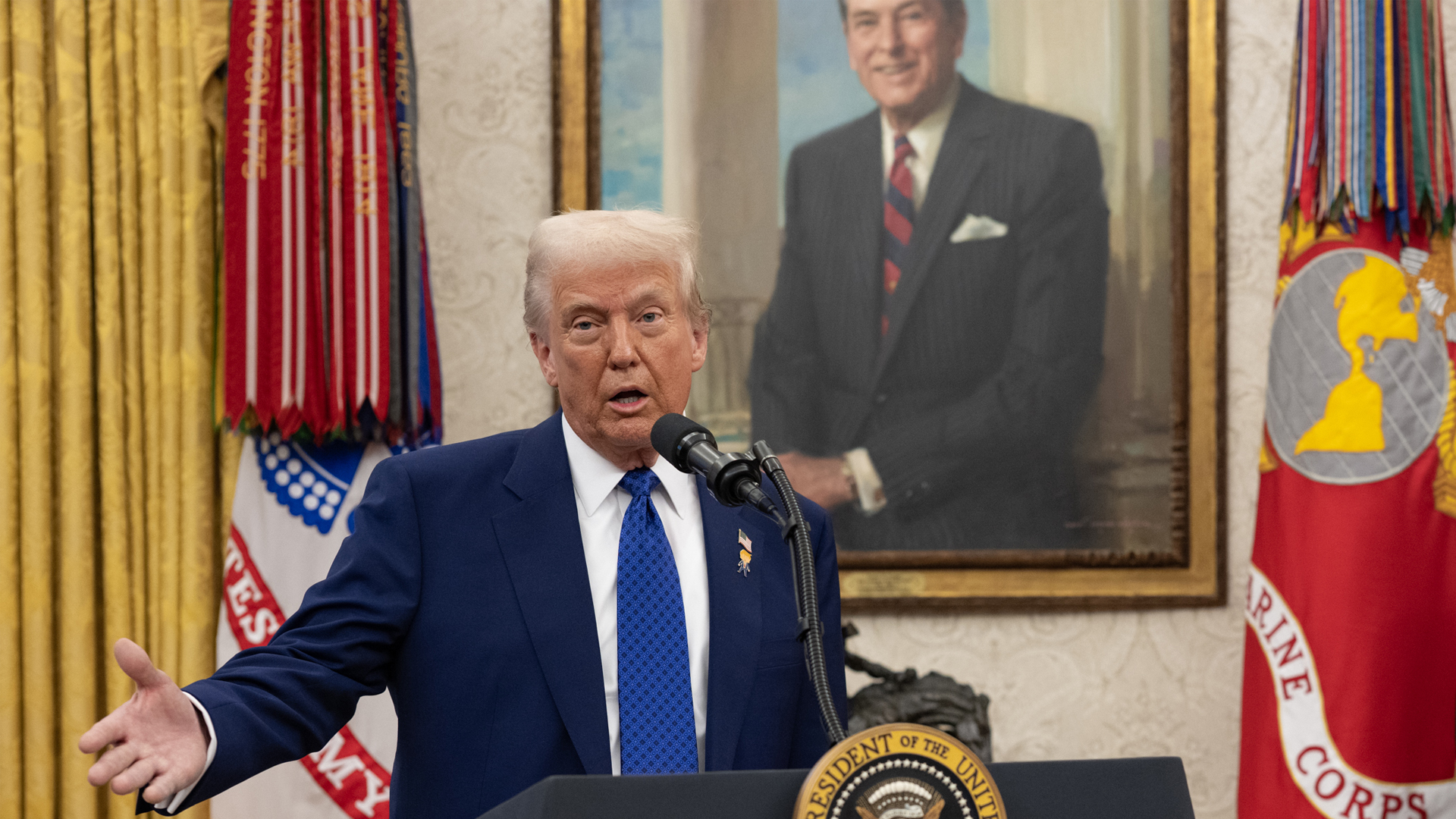 President Donald Trump speaks in front of a portrait of President Ronald Reagan in the Oval Office on Feb. 12. (The White House, Public domain, via Wikimedia Commons)