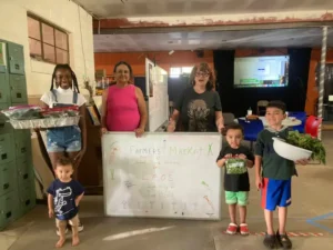 Local kids learned to harvest and sell food during a youth-led farmers market event at Leo’s. (Photo by Miracle Martinez)