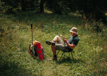 A hiker reads in the woods (iStock image)