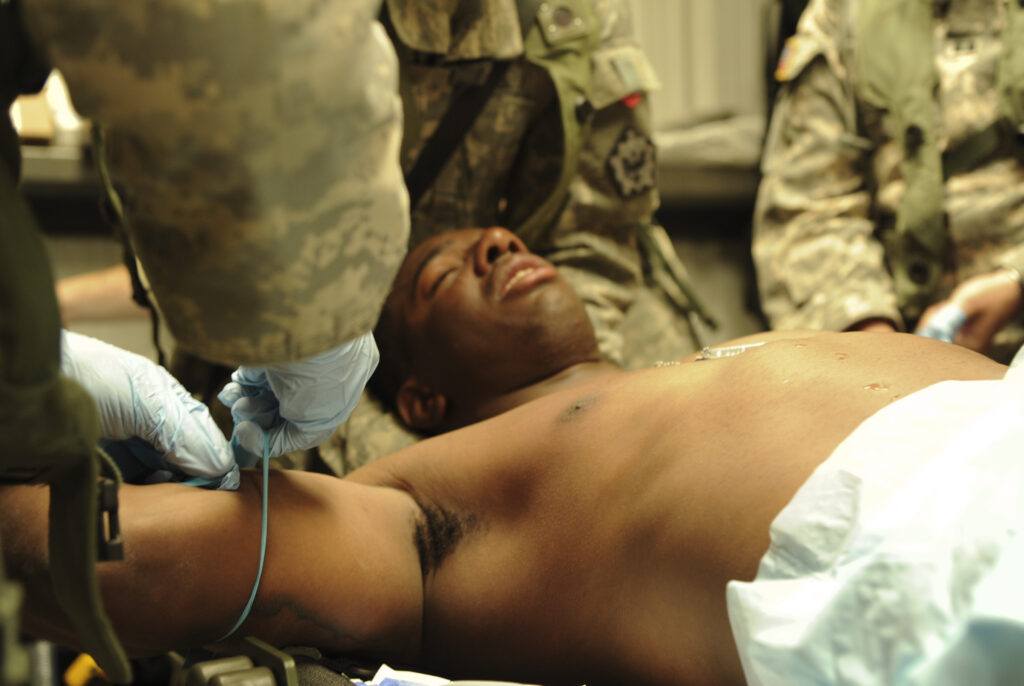 Medics treat a U.S. Army soldier for heat exhaustion at the Fort Irwin National Training Center in southern California. Such cases are increasing as global temperatures rise. From 2020 to 2024, the annual rate of heat exhaustion among service members jumped 52%. (Staff Sgt. Dayton Mitchell / U.S. Air Force)