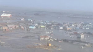 Ex-Typhoon Halong’s storm surge and powerful winds knocked homes off their foundations and set some afloat. (U.S. Coast Guard)