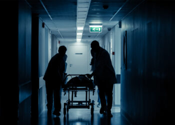 Hospital staff bring a patient on a gurney (iStock image)