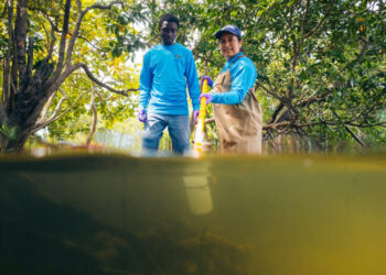 FIU Ph.D. students in Quinete's lab, Joshua Ocheje and Carolina Cuchimaque Lugo, collect water samples to test them for PFAS. (Credit: Anthony Sleiman/Florida International University)