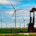 An aging oil pumpjack surrounded by wind turbines in West Texas (iStock image)