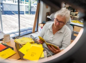 Feller organizes several “Rite in the Rain” field books in her home office. She has dozens of notebooks dating back to about 25 years of scientific research. She is currently working on researching psyllid insects and their effects on mangroves. (Photo by Jason Matthew Walker)