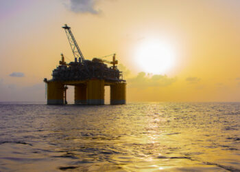 An offshore drilling platform at sunset in the Gulf (iStock image)