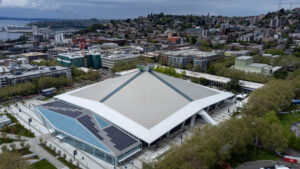 Seattle’s Climate Pledge Arena has lowered its emissions with solar power from a local array and has even electried its Zambonis. But reports have raised questions about the quality of carbon offsets it purchased. (Sea Cow, CC BY-SA 4.0, via Wikimedia Commons)