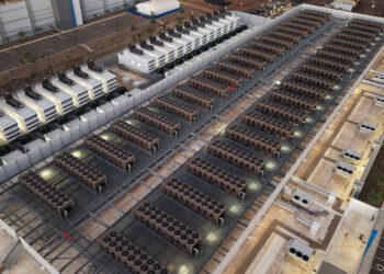 Cooling towers and backup generators on the roof of a data center (Rsparks3, CC0, via Wikimedia Commons)