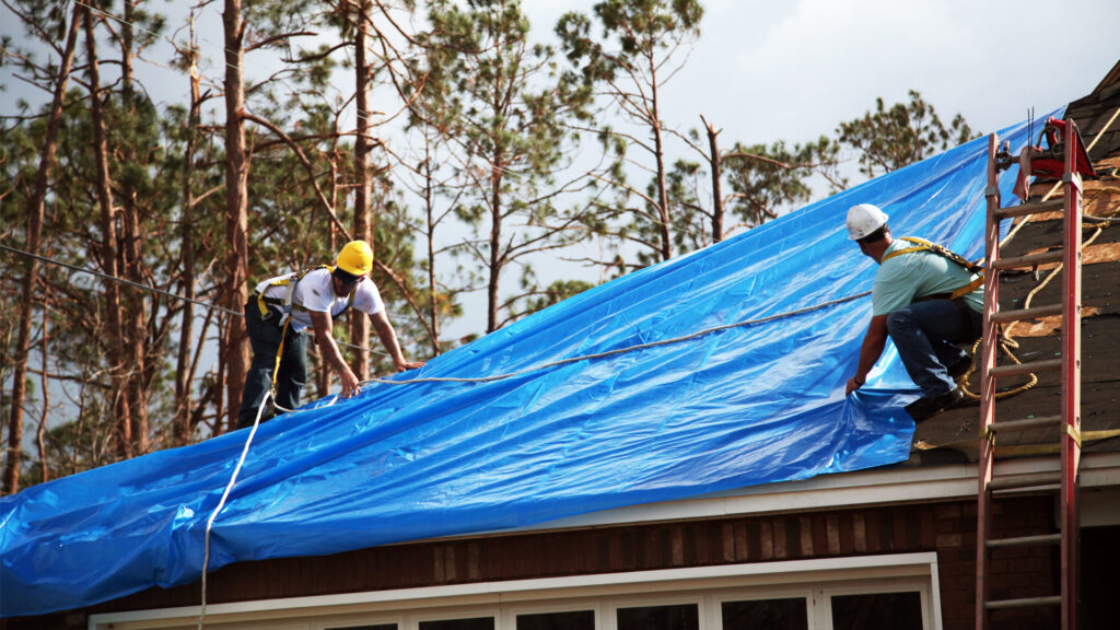 U.S. Army Corps of Engineers workers install temporary roofing on homes of Florida Panhandle residents as part of Operation Blue Roof following Hurricane Michael in 2018 (Pfc. Kaleah Fields/CAISE, via Defense Visual Information Distribution Service)