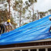 U.S. Army Corps of Engineers workers install temporary roofing on homes of Florida Panhandle residents as part of Operation Blue Roof following Hurricane Michael in 2018 (Pfc. Kaleah Fields/CAISE, via Defense Visual Information Distribution Service)