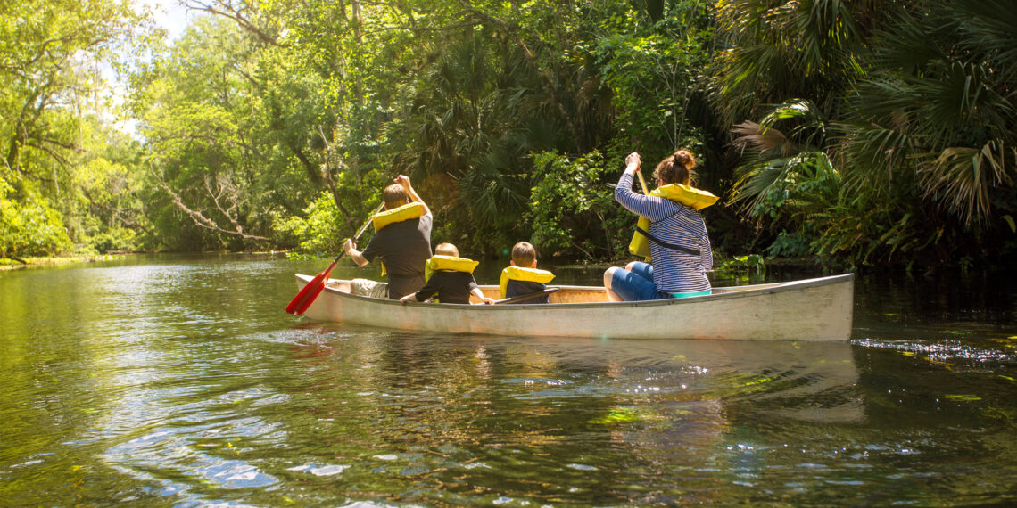 A family paddles in a canoe (iStock image)