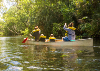 A family paddles in a canoe (iStock image)