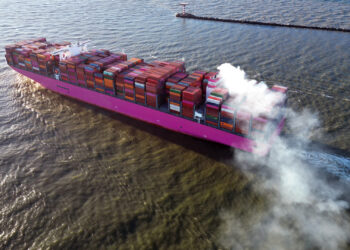 Smoke coming from a container ship as it leaves port (iStock image)