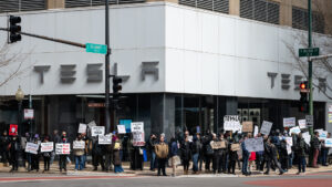 A protest at a Tesla dealership in Chicago in March (Paul Goyette, CC BY 2.0, via Wikimedia Commons)