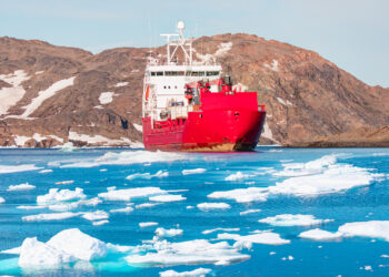 A ship leaving Tasiilaq, Greenland, after unloading at the docks in the harbor. (iStock image)