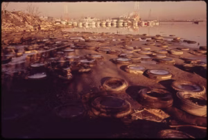 Discarded tires litter the shorefront of Baltimore Harbor in 1973. (Jim Pickerell, Documerica Project, U.S. National Archives)